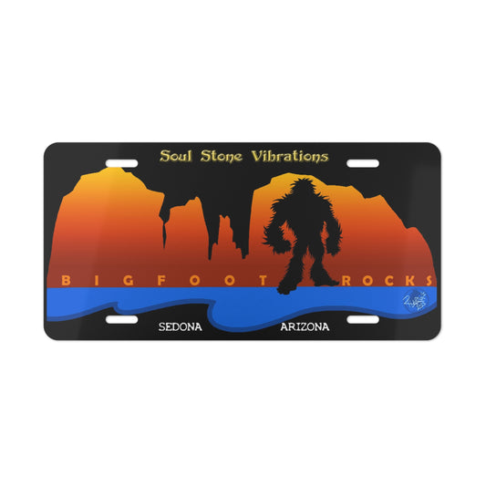 Bigfoot Rocks silhouette w/orange text vehicle Vanity Plate